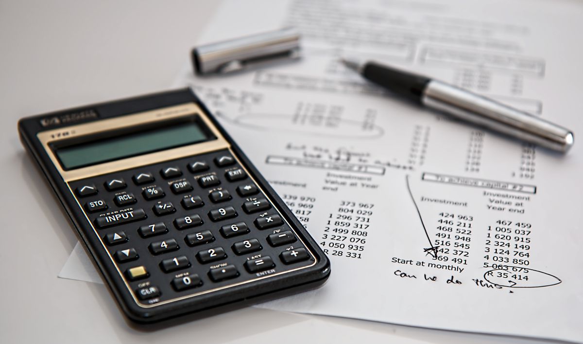 Calculator and handwritten cash-flow notes on a desk
